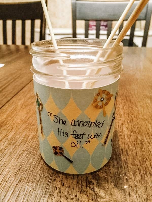 Small glass jar with essential oil and wooden skewers with the words "She anointed His feet with oil" | 6 Special Christian Easter Activities for Families