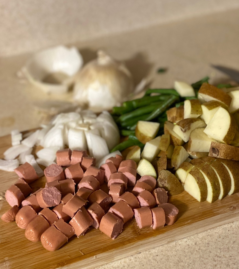 hot dogs, potatoes, onions, green beans on cutting board