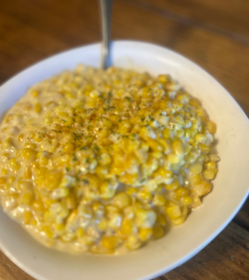 homemade creamed corn in a white bowl