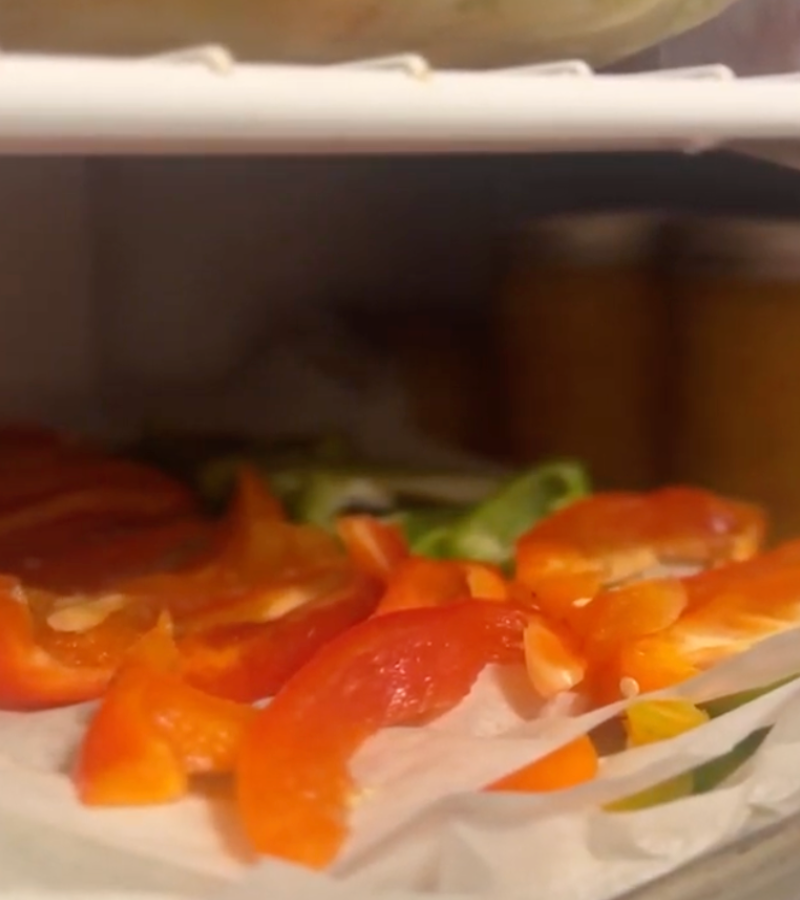 bell pepper slices on parchment in freezer | How to Preserve Bell Peppers