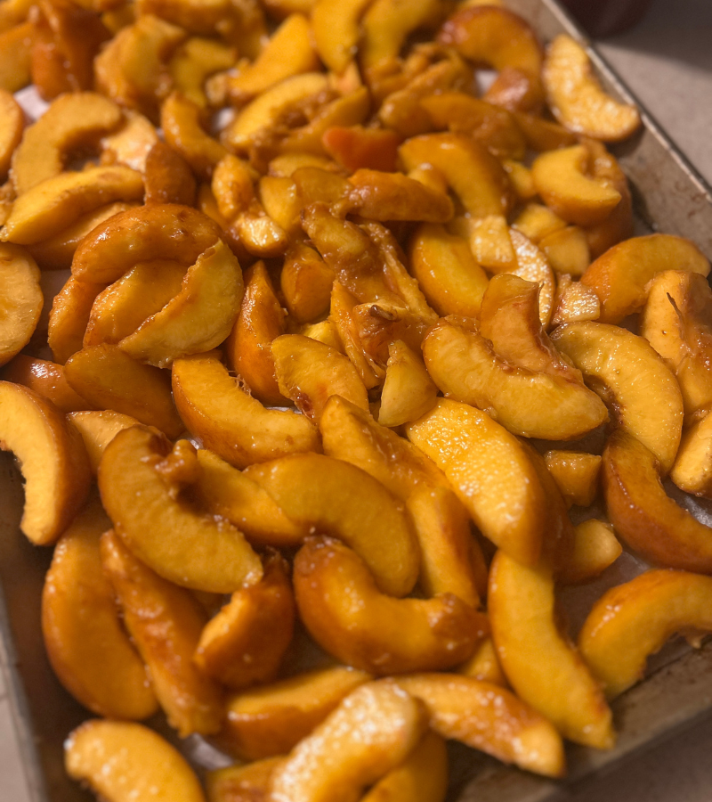 peach slices on a baking sheet ready o be flash frozen