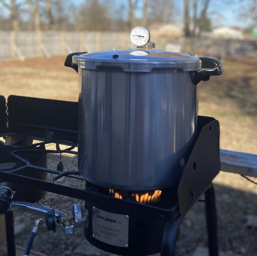 pressure canner on outdoor camp stove