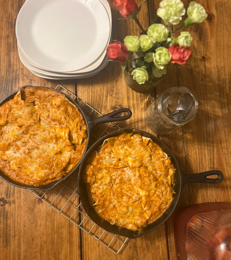 cheesy chicken enchiladas in cast iron skillets
